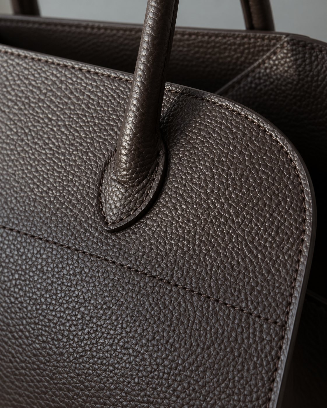 Close-up of full grain Italian leather on the LISHÉ Vira Moka bag, pebbled grain and stitching