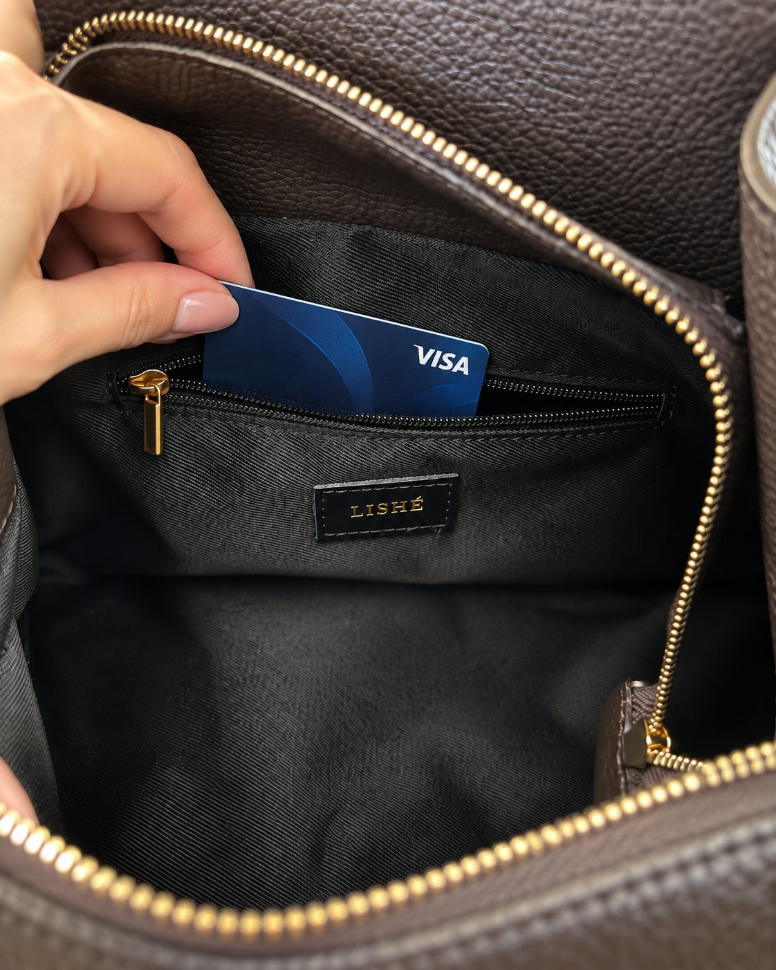 Inside the LISHÉ Vira Moka: zipped inner pocket and black lining